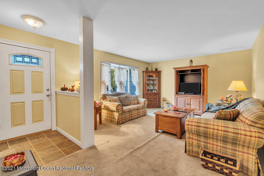 146 Cedar Swamp Road Jackson, NJ 08527 - Photo 12 of 48 a living room with furniture and a flat screen tv