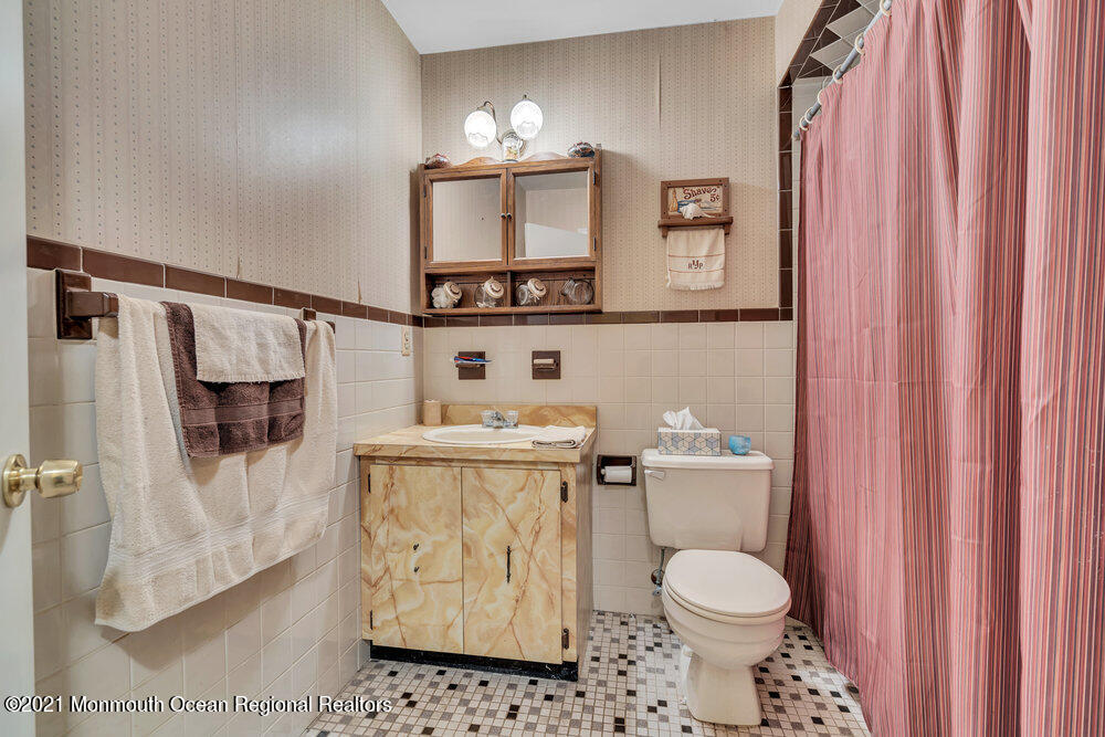 146 Cedar Swamp Road Jackson, NJ 08527 - Photo 16 of 48 a white toilet sitting next to a bathroom sink