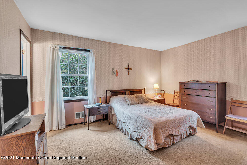 146 Cedar Swamp Road Jackson, NJ 08527 - Photo 17 of 48 a bedroom with a bed and a flat screen tv