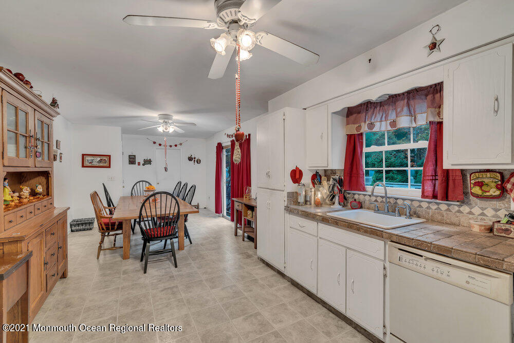 146 Cedar Swamp Road Jackson, NJ 08527 - Photo 28 of 48 a view of a kitchen and a dining table chairs