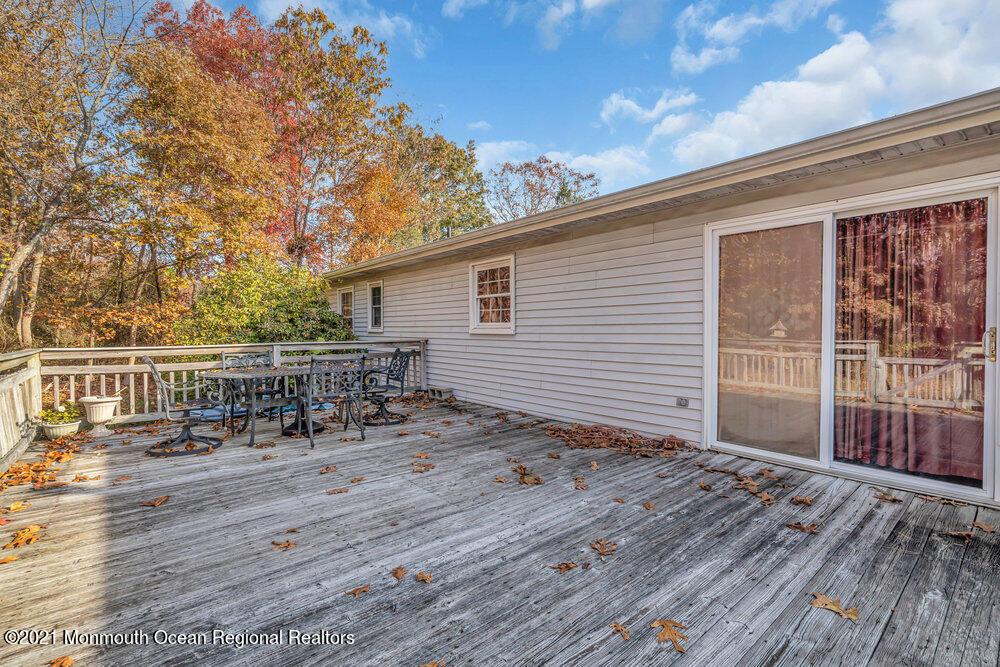 146 Cedar Swamp Road Jackson, NJ 08527 - Photo 36 of 48 a view of a balcony with chairs and wooden fence