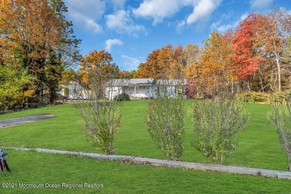 146 Cedar Swamp Road Jackson, NJ 08527 - Photo 5 of 48 a view of a garden with a building in the background