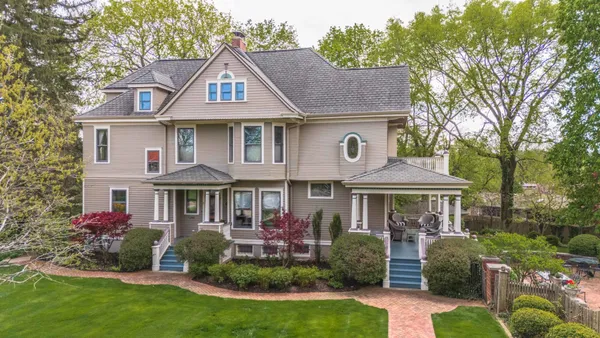 a front view of a house with a yard table and chairs