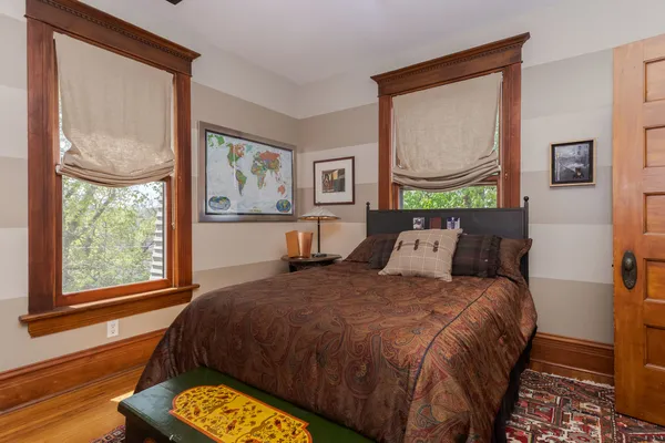 a bedroom with a bed and a window