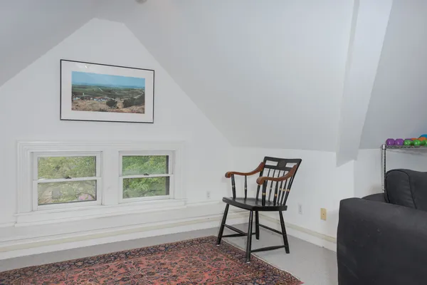 a view of a brick house with a yard and plants