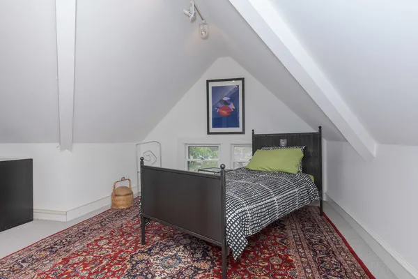 a front view of a house with a garden and fountain