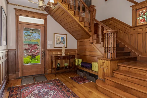 a view of entryway and hall with wooden floor