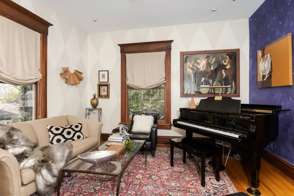 a living room with furniture and a piano