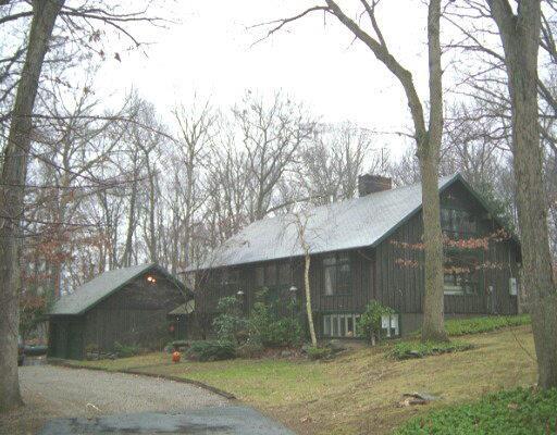 15 Birch Hill Road Weston, CT 06883 - Photo 1 of 1 a backyard of a house with large trees and a wooden fence