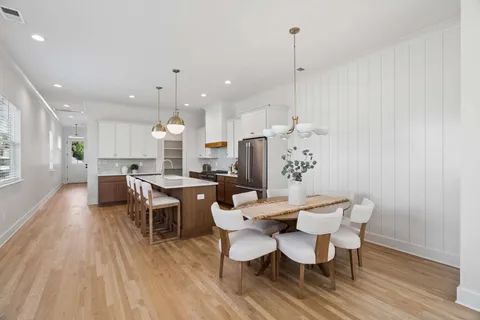a dining room with furniture and wooden floor
