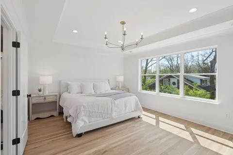 a bedroom with a large bed and a window