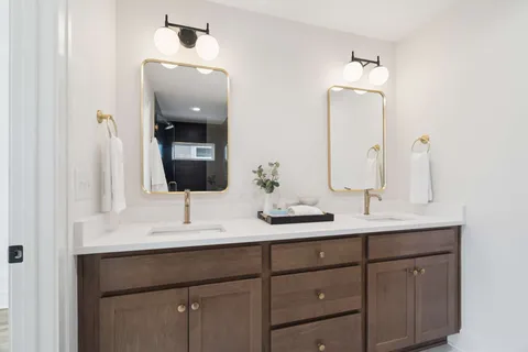 a bathroom with a double vanity sink and mirror