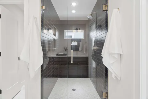 a large bathroom with a tub sink and mirror