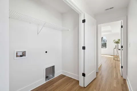 a room with wooden floor and white walls