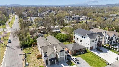 an aerial view of multiple houses with yard