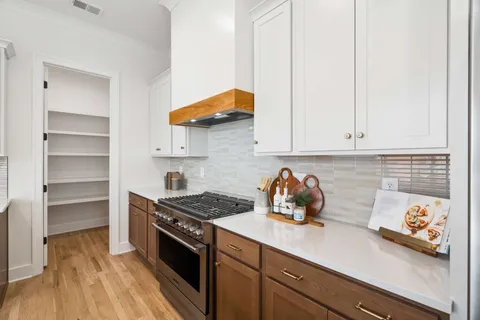 a kitchen with stainless steel appliances granite countertop a sink and a stove