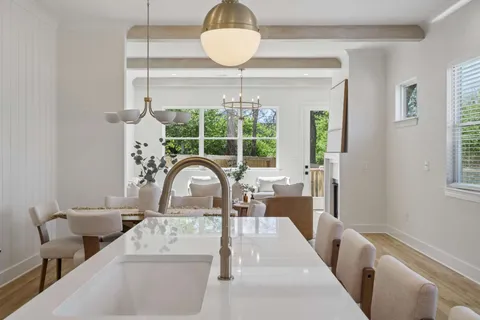 a living room with furniture a window and a chandelier