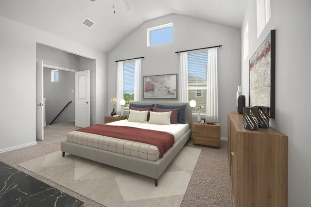 a spacious bedroom with a bed and a couch