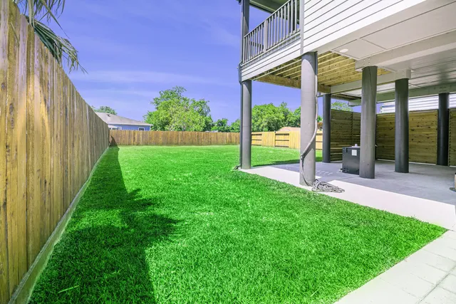 a view of a house with a yard and sitting area