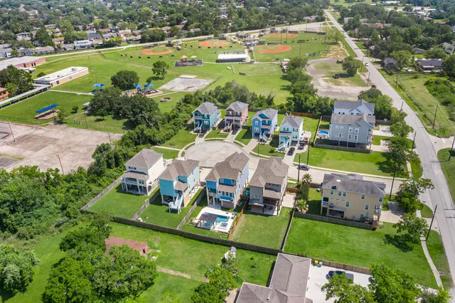 an aerial view of a house with a garden and lake view