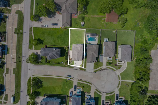 an aerial view of multiple houses with yard