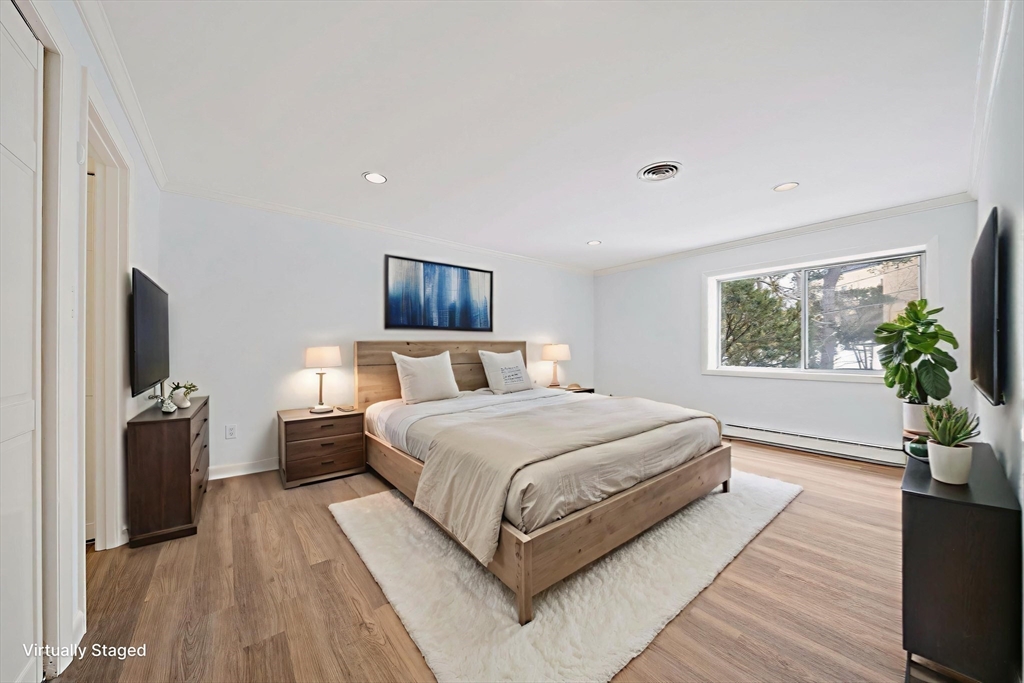 1204 Greendale Avenue, Unit 128 Needham, MA 02492 - Photo 14 of 27 a bedroom with a large bed and a flat screen tv