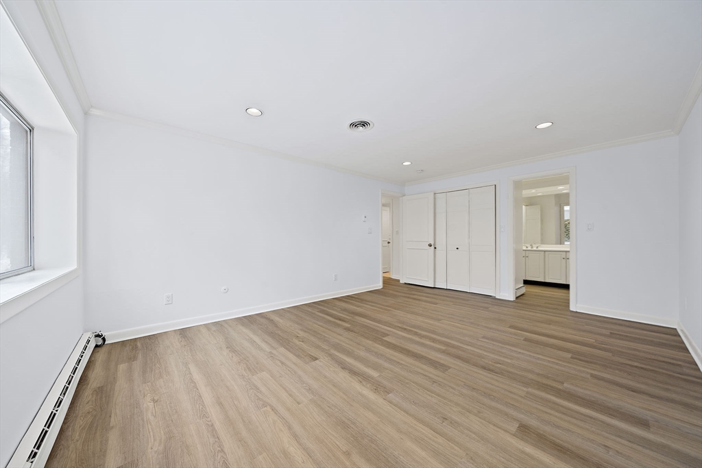 1204 Greendale Avenue, Unit 128 Needham, MA 02492 - Photo 15 of 27 a view of an empty room with wooden floor and closet