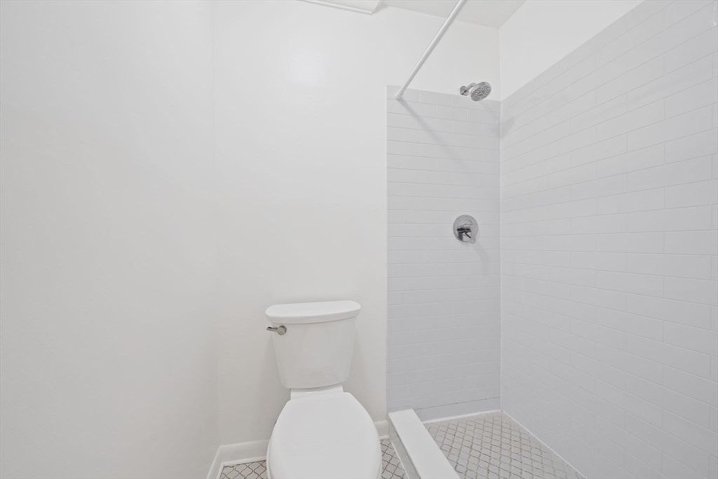 1204 Greendale Avenue, Unit 128 Needham, MA 02492 - Photo 17 of 27 a white toilet sitting next to a shower