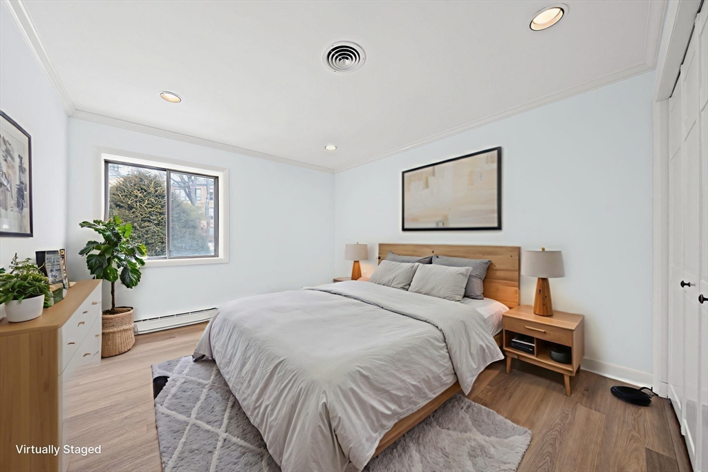 1204 Greendale Avenue, Unit 128 Needham, MA 02492 - Photo 19 of 27 a bedroom with a bed and a potted plant