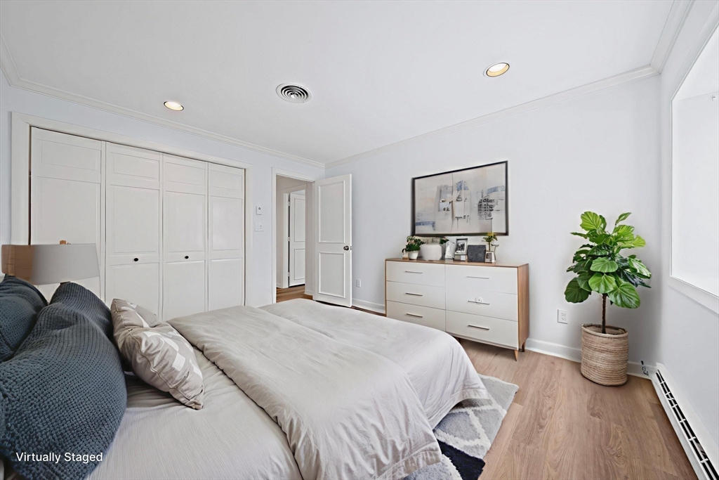 1204 Greendale Avenue, Unit 128 Needham, MA 02492 - Photo 20 of 27 a bedroom with a bed and a potted plant