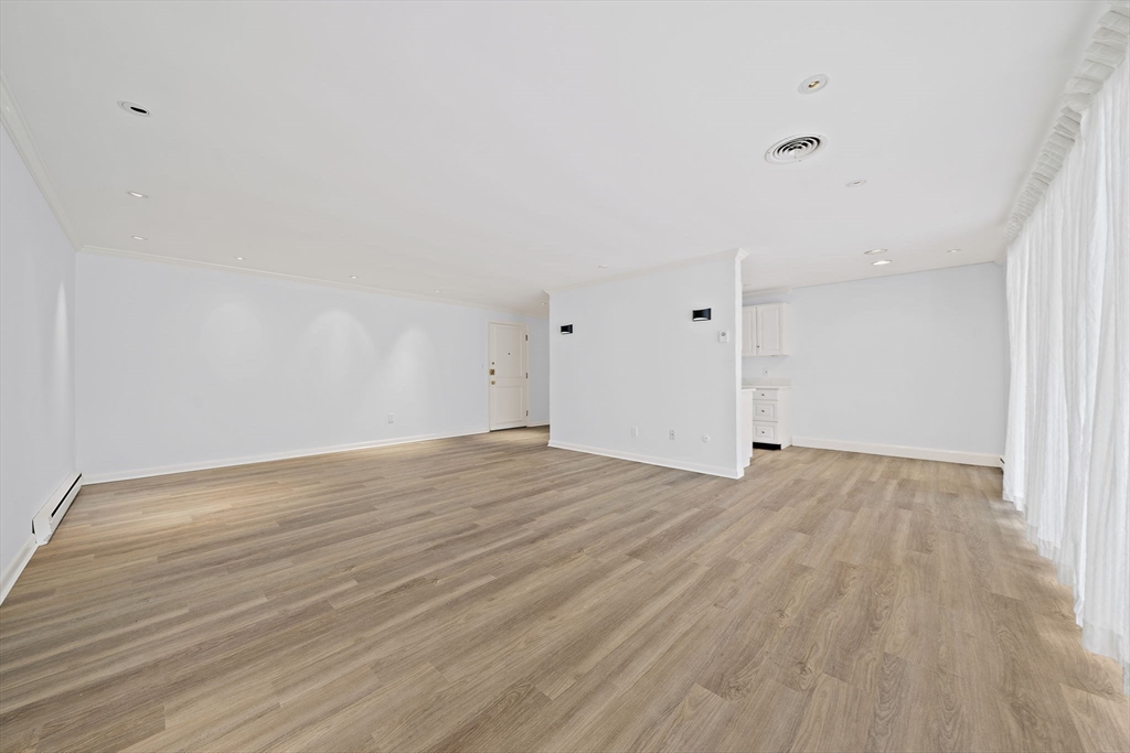 1204 Greendale Avenue, Unit 128 Needham, MA 02492 - Photo 6 of 27 a view of an empty room with wooden floor