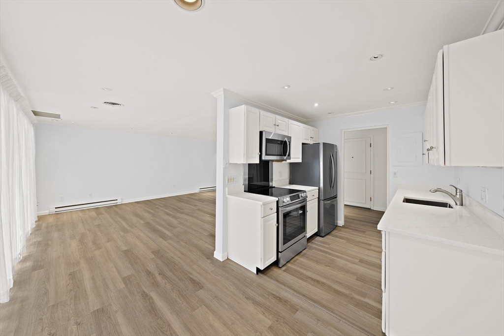 1204 Greendale Avenue, Unit 128 Needham, MA 02492 - Photo 10 of 27 a kitchen with granite countertop a sink and steel appliances