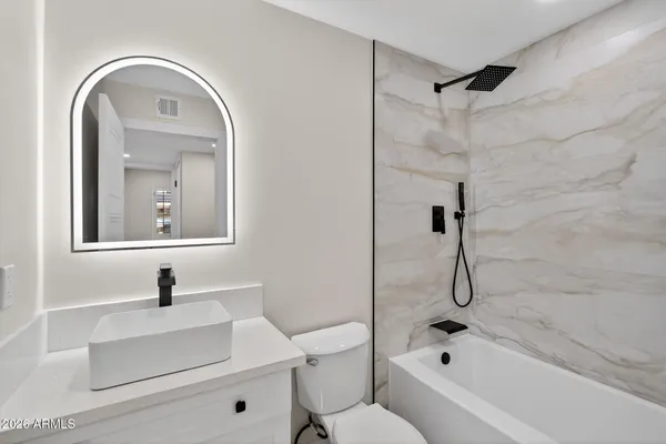 a bathroom with a sink a toilet and a bathtub