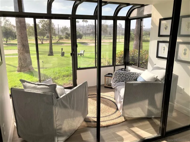 a living room with furniture and a floor to ceiling window