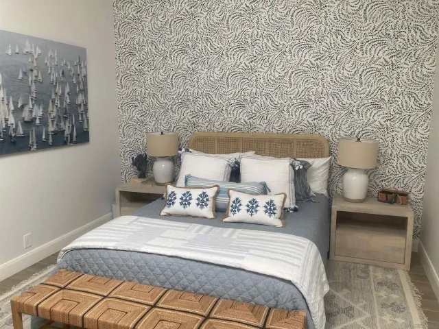 a bedroom with a bed and a wall painting