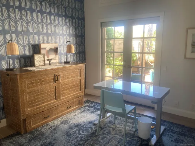 a room with a table chair and a window