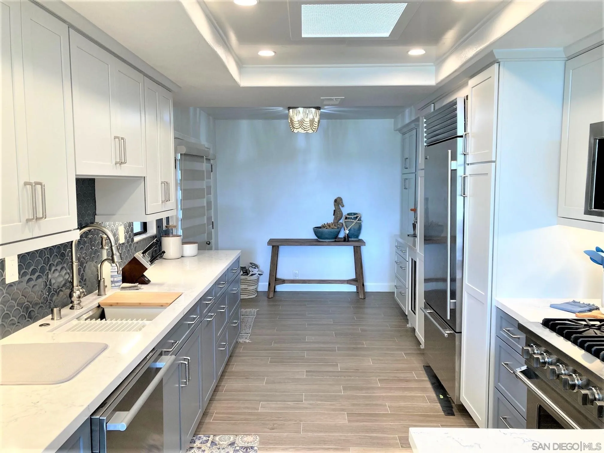 4023 Avenida Brisa Rancho Santa Fe, CA 92091 - Photo 8 of 24 a large kitchen with stainless steel appliances granite countertop a sink stove and refrigerator
