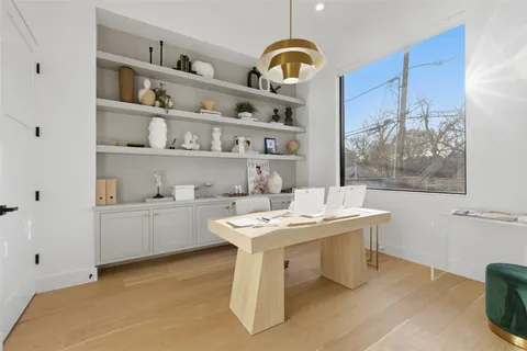 a room with a table chairs and a stove