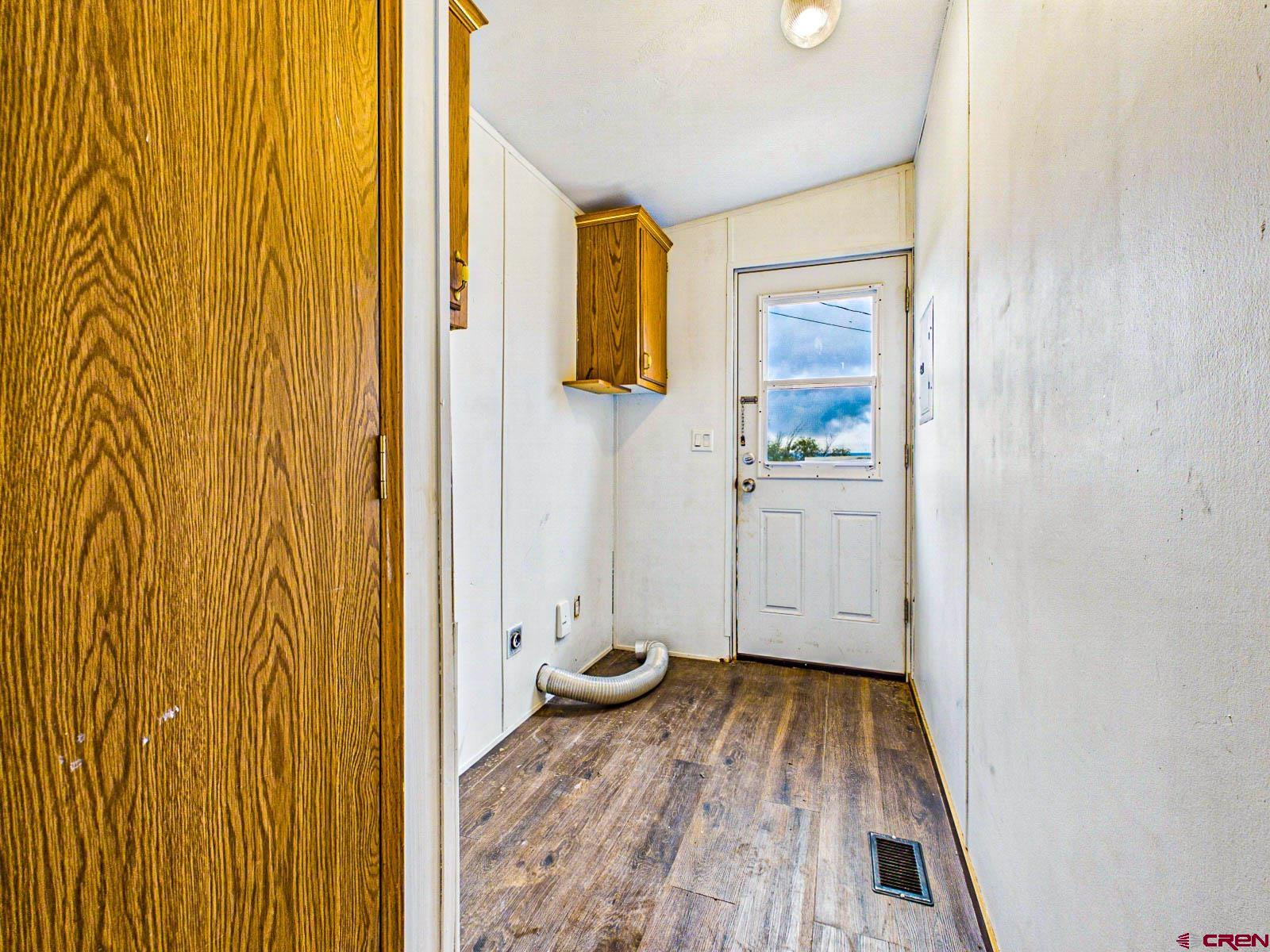 15484 Peach Road Cedaredge, CO 81413 - Photo 14 of 35 a view of a hallway with wooden floor and closet area