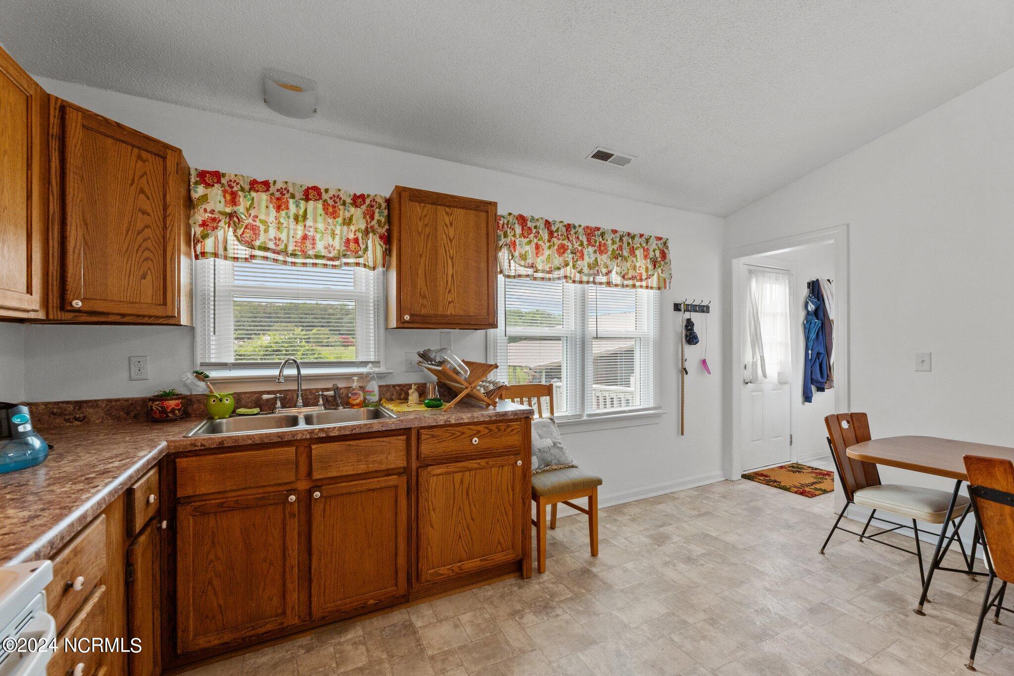 3398 Alvin Road Grimesland, NC 27837 - Photo 10 of 52 KITCHEN TOWARDS DINING AND LAUNDRY