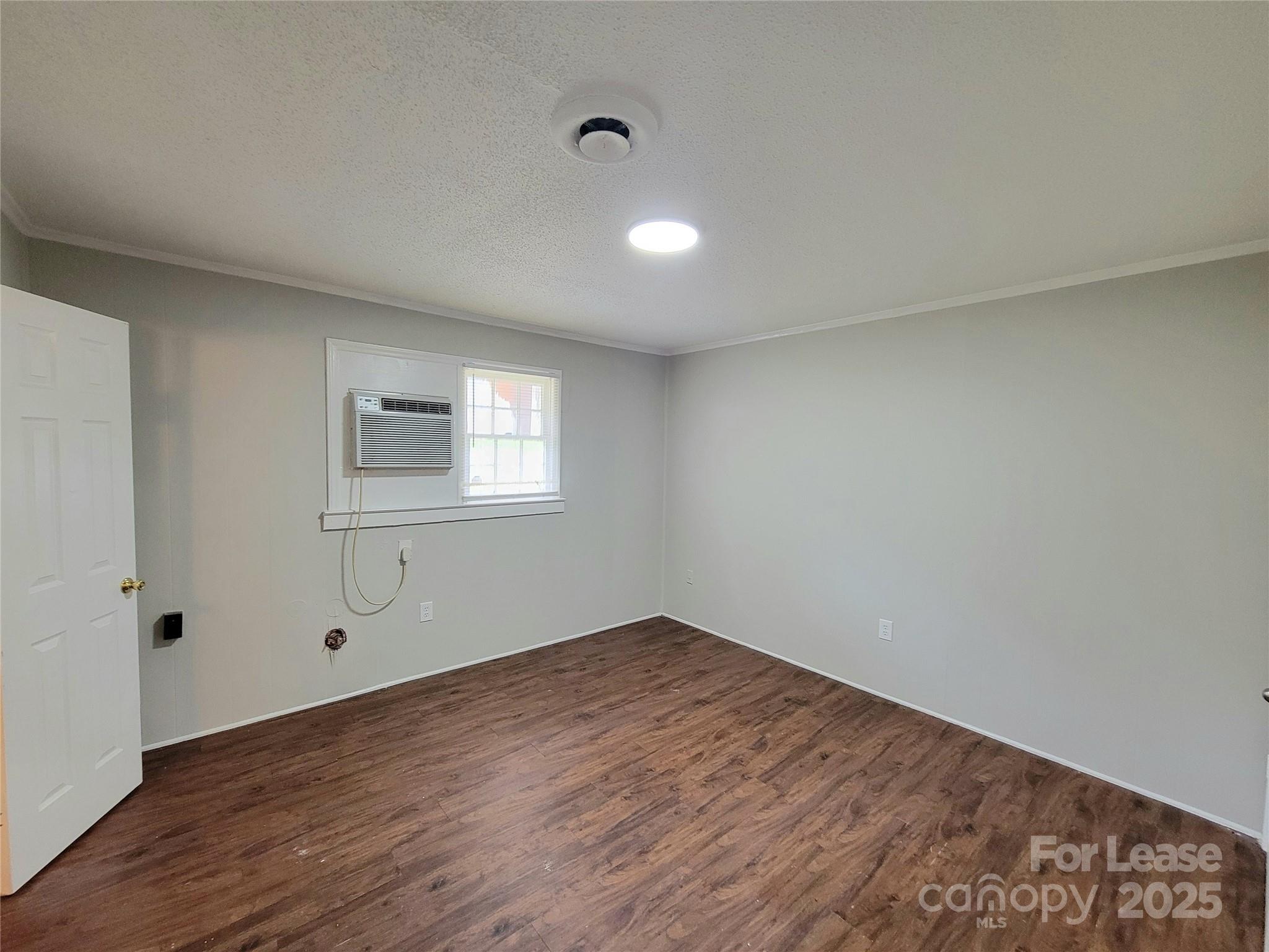 1203 Butler Street, Unit 1203D Gastonia, NC 28054 - Photo 3 of 5 a view of empty room with wooden floor