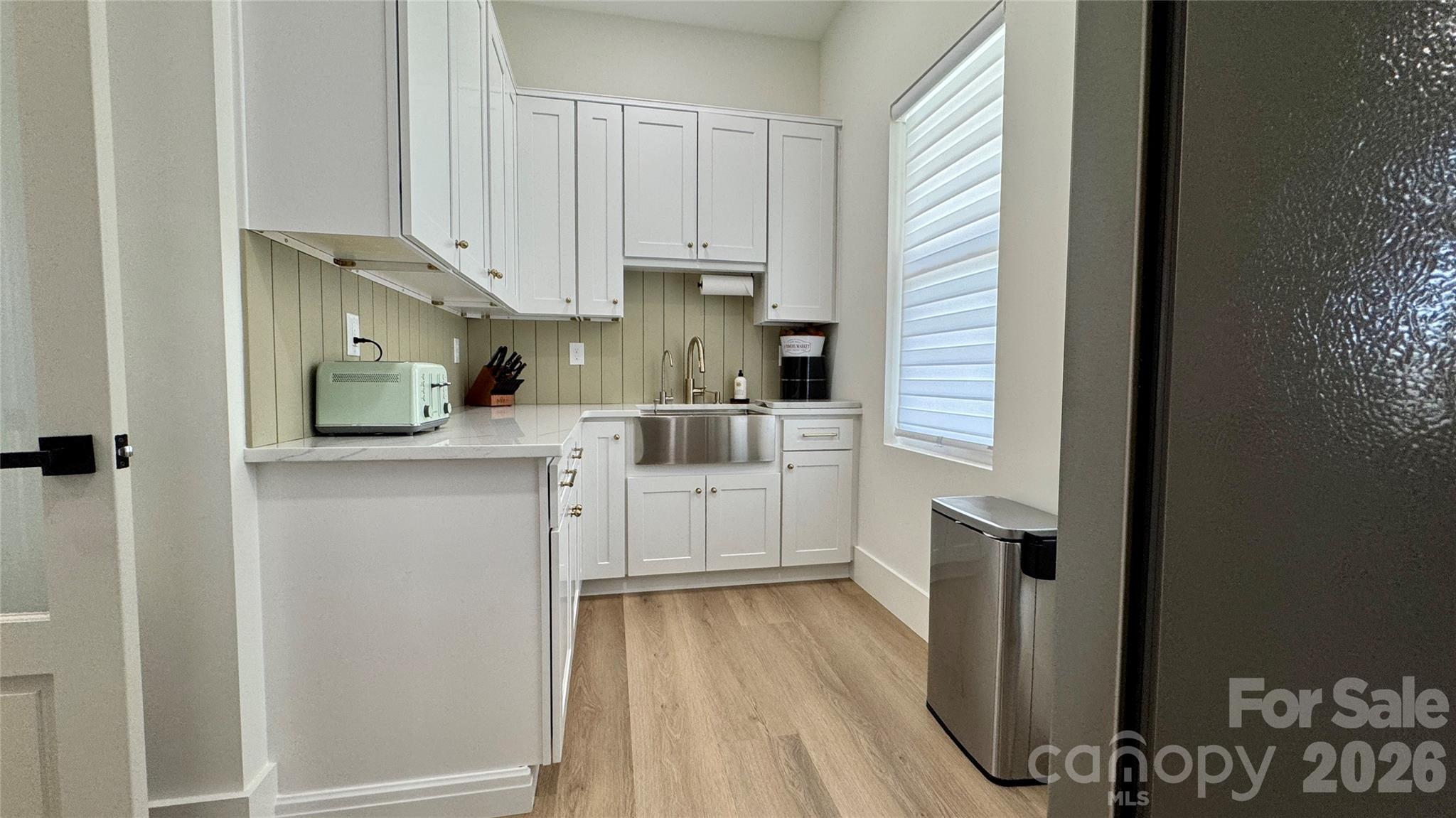 1360 Sain Road Hickory, NC 28602 - Photo 16 of 47 a kitchen with white cabinets and white appliances