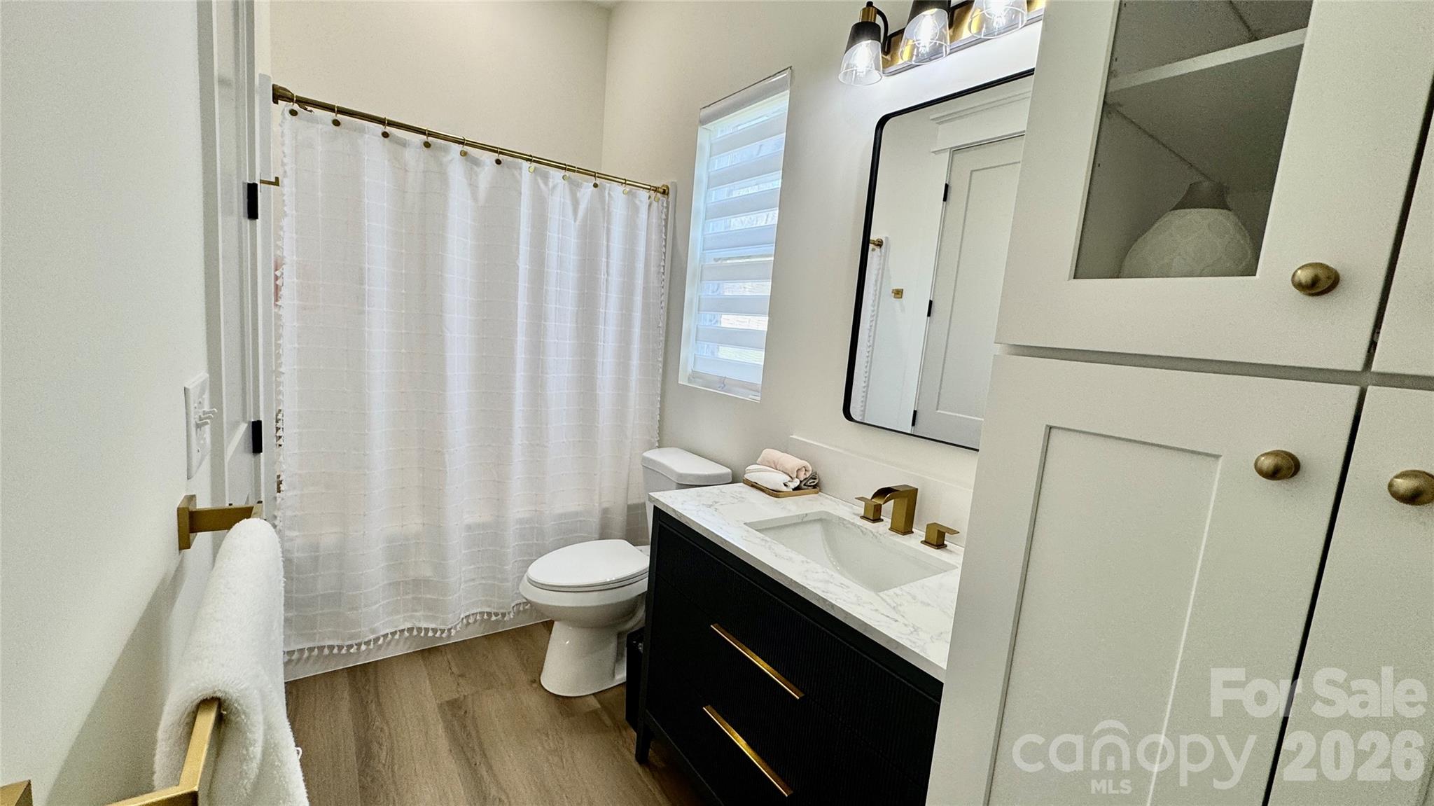 1360 Sain Road Hickory, NC 28602 - Photo 29 of 47 a bathroom with a sink a toilet and shower curtain