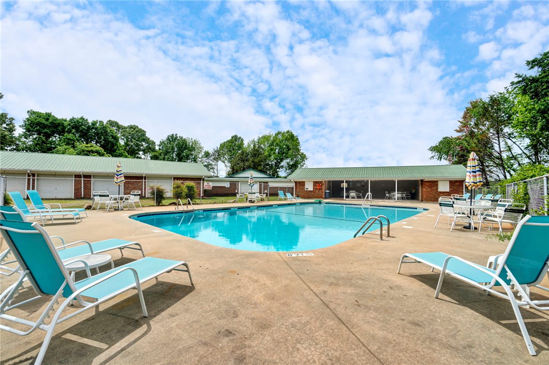 104 Captains Way Anderson, SC 29625 - Photo 42 of 47 This inviting outdoor pool area features ample space for relaxation and enjoyment under clear skies.
