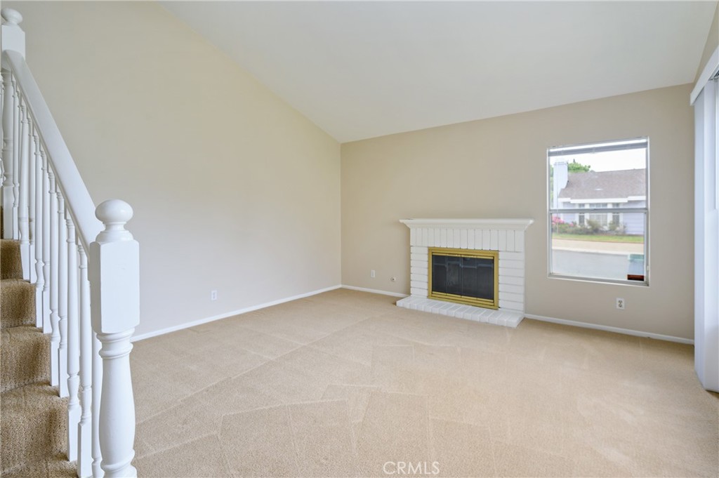 25 Sweet Rain Irvine, CA 92614 - Photo 2 of 45 an empty room with a fireplace and windows