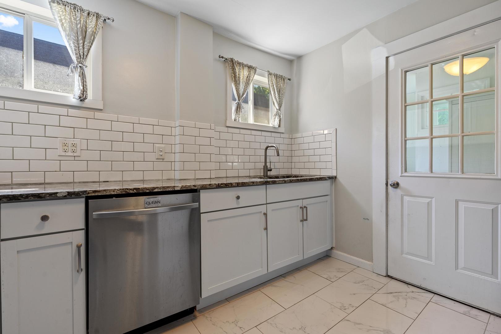 1643 Pine Road Homewood, IL 60430 - Photo 9 of 20 a kitchen with stainless steel appliances granite countertop white cabinets and window