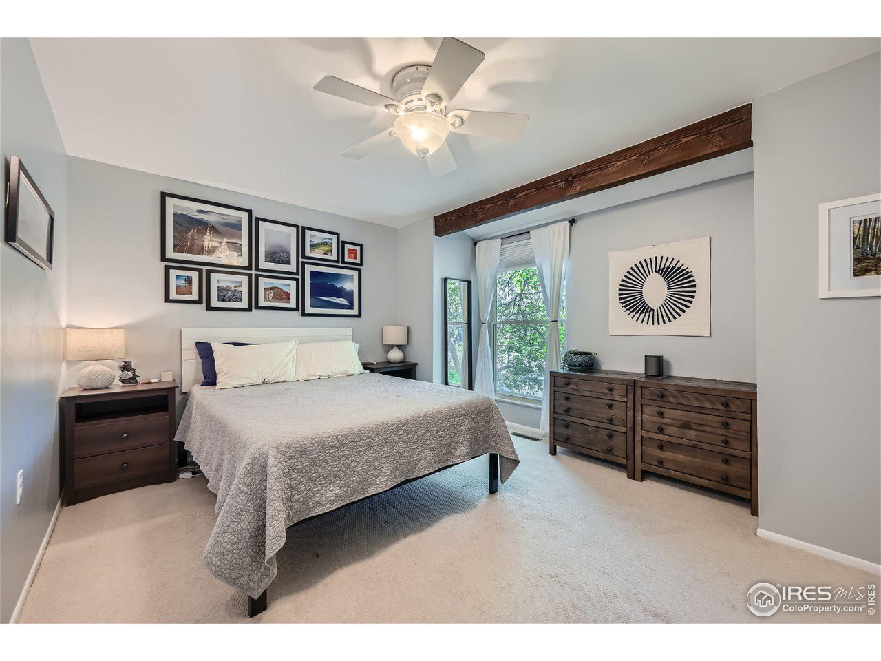 1175 Bear Mountain Drive, Unit A Boulder, CO 80305 - Photo 13 of 31 a bedroom with a bed and a chandelier