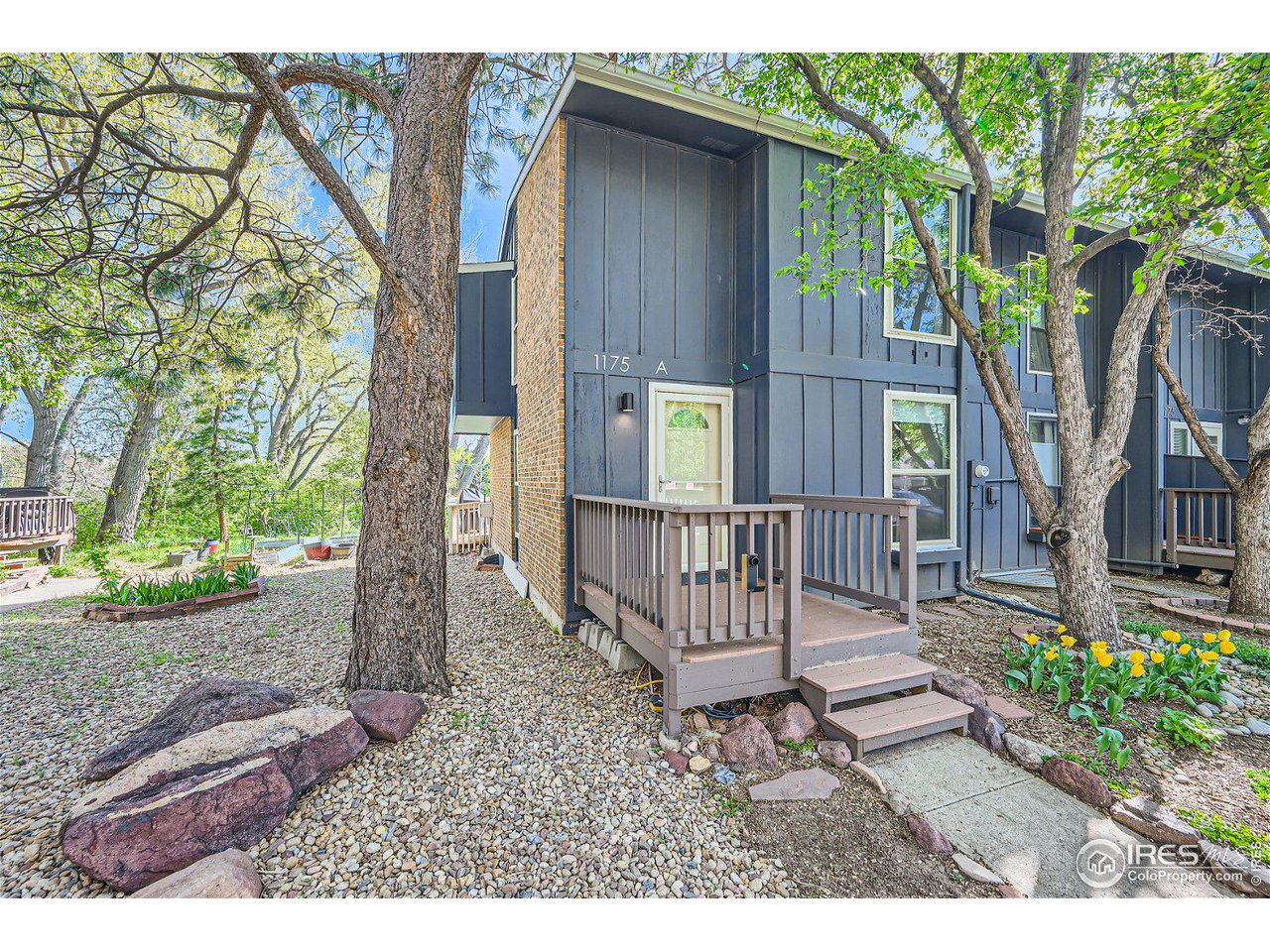 1175 Bear Mountain Drive, Unit A Boulder, CO 80305 - Photo 2 of 31 a view of a wooden house with a bench and a yard