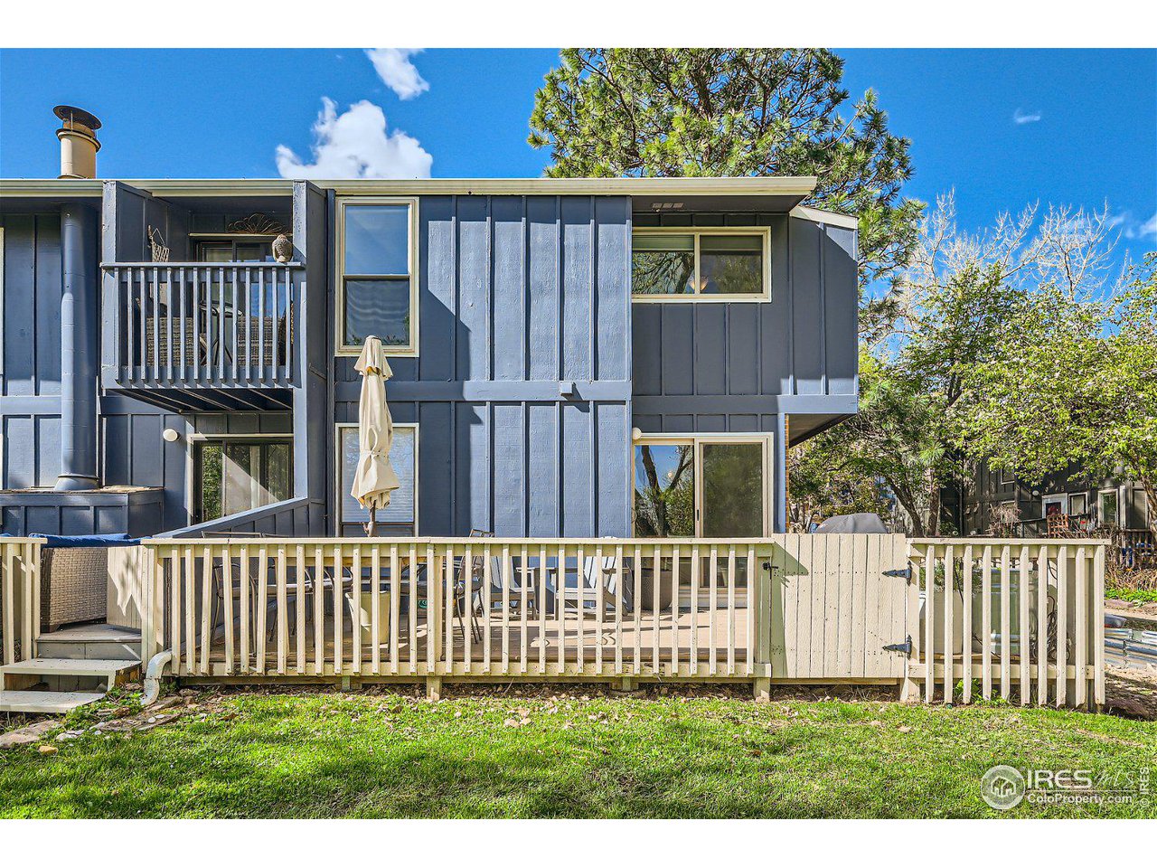 1175 Bear Mountain Drive, Unit A Boulder, CO 80305 - Photo 26 of 31 a view of a house with a small yard and wooden fence