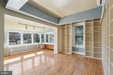 wooden floor in an empty room with a window